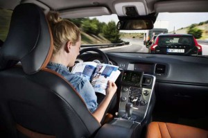 woman reading while driving down motorway